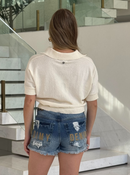 Textured Brenda blouse by Animale displayed on a mannequin, showcasing its unique fabric and stylish design.