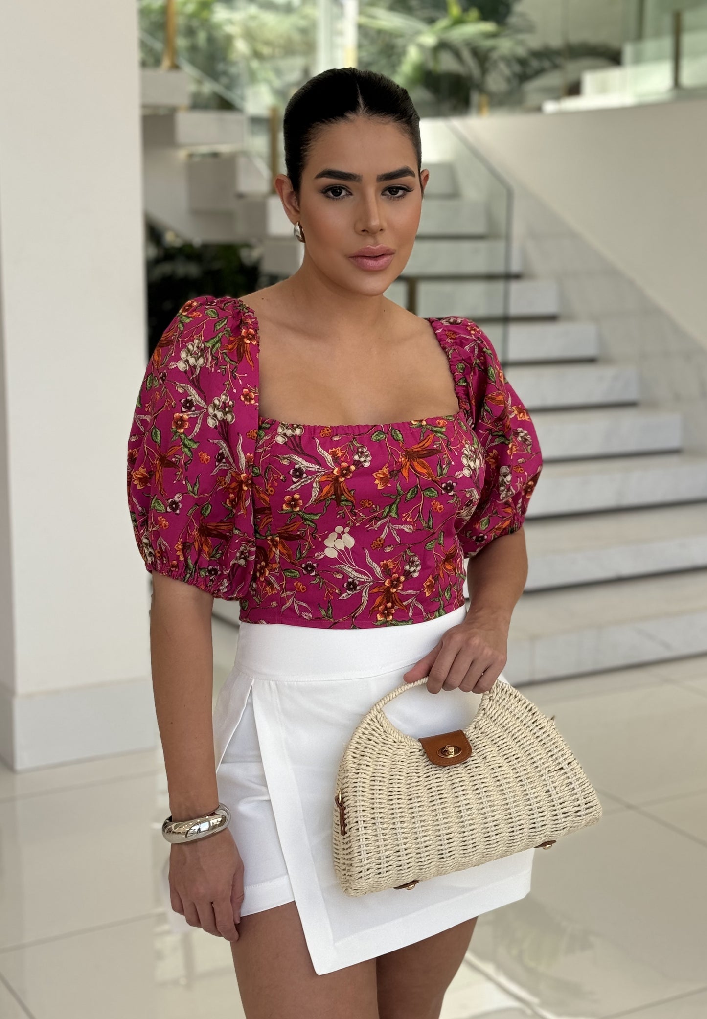 Cropped floral top by DELPHYNE featuring a vibrant floral print and stylish design, perfect for casual wear.