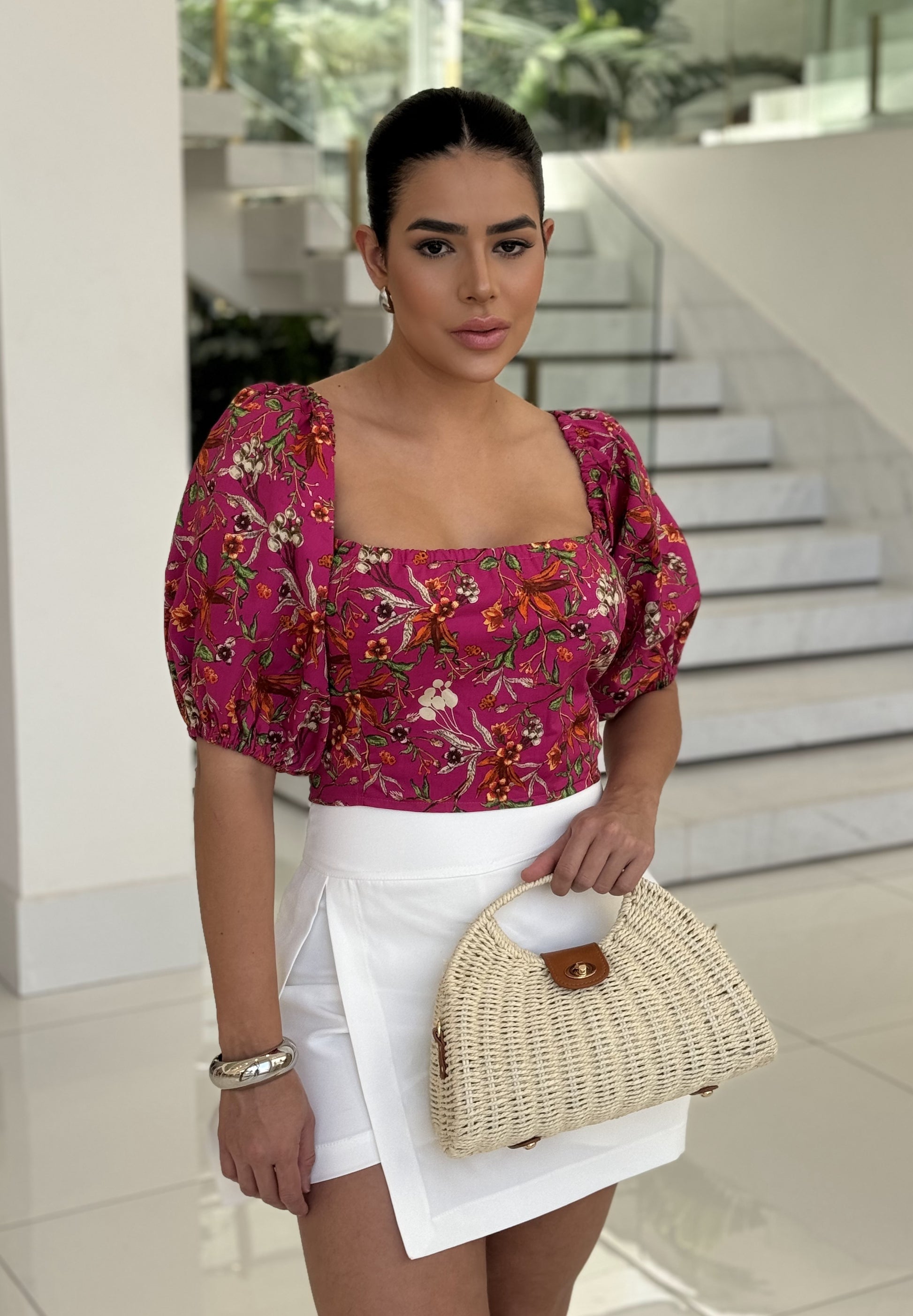 Cropped floral top by DELPHYNE featuring a vibrant floral print and stylish design, perfect for casual wear.