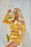 FARM Abacaxi blazer featuring a vibrant pattern and tailored fit, showcased on a model in a bright setting.