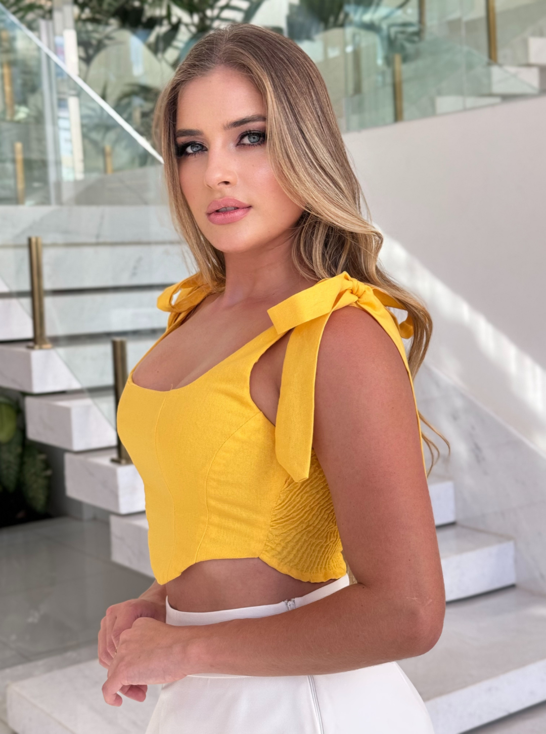 Cropped yellow top from FARM, featuring a stylish design and lightweight fabric, ideal for casual summer outfits.