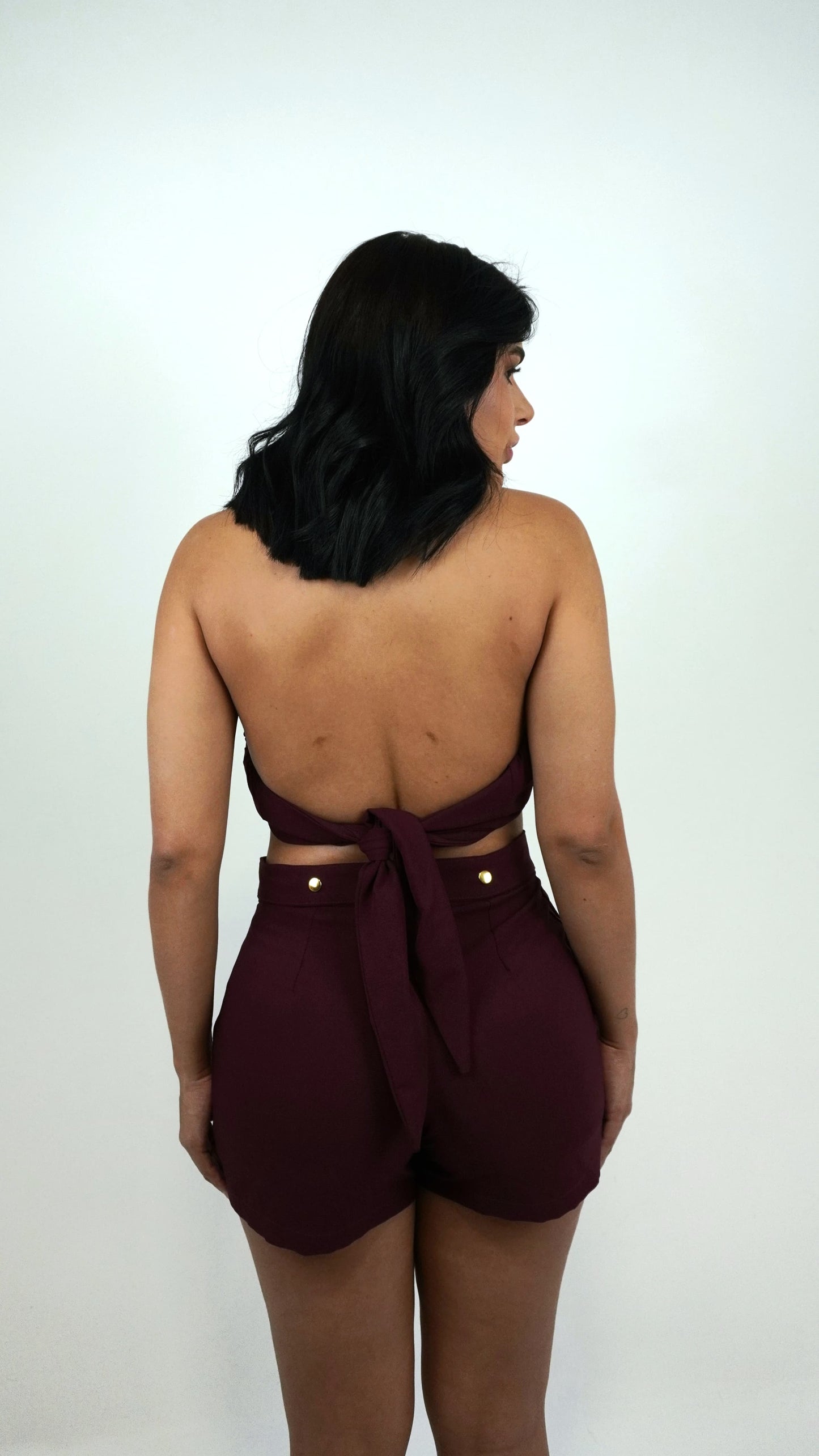 Cherry red short with belt from Wanessa Lopez Concept, showcasing a stylish and modern design.