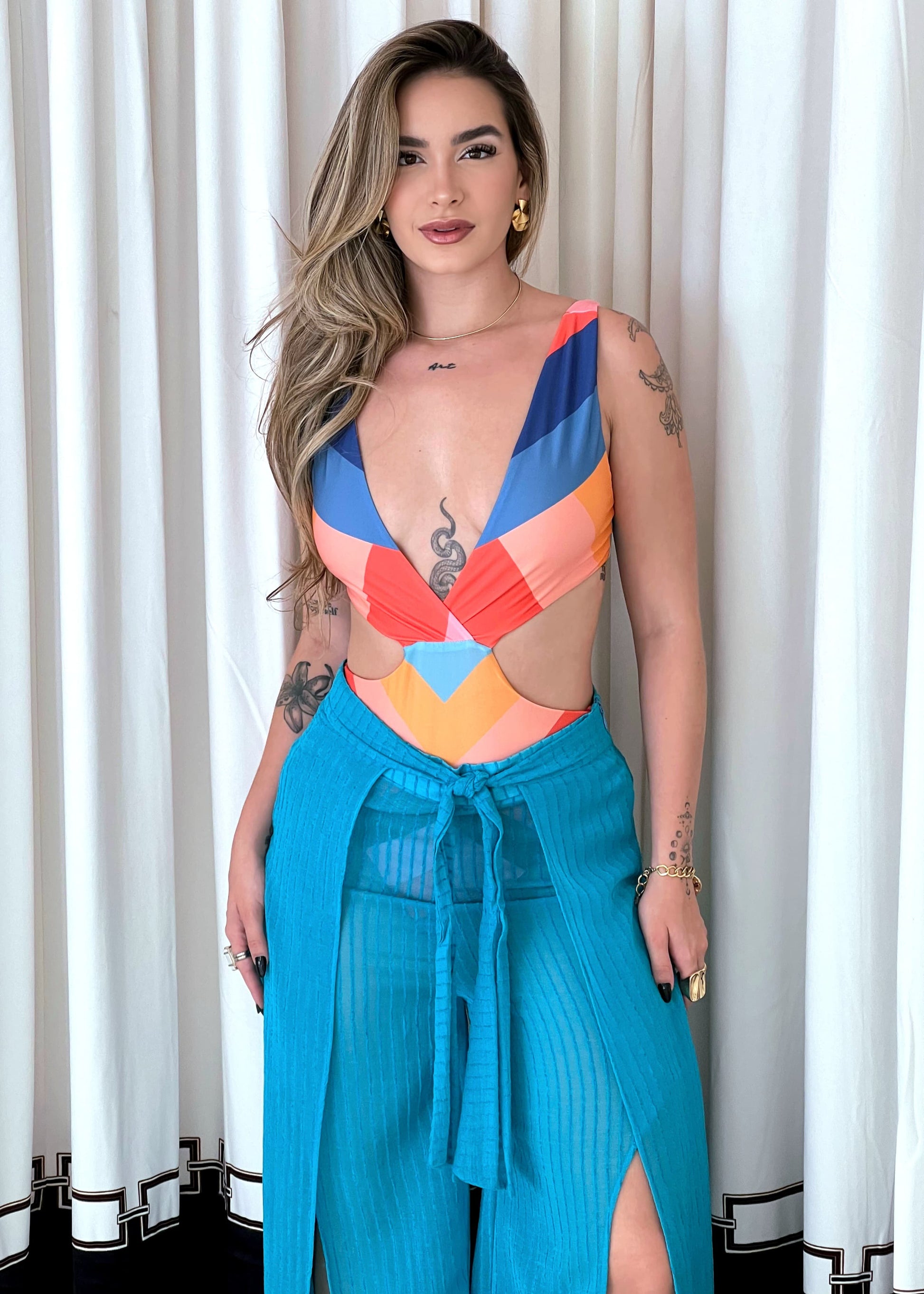 Colorful MAIO LOCALIZADO LISTRA AMANDA ESTAMPADO swimsuit by Wanessa Lopez Concept displayed on a flat surface.